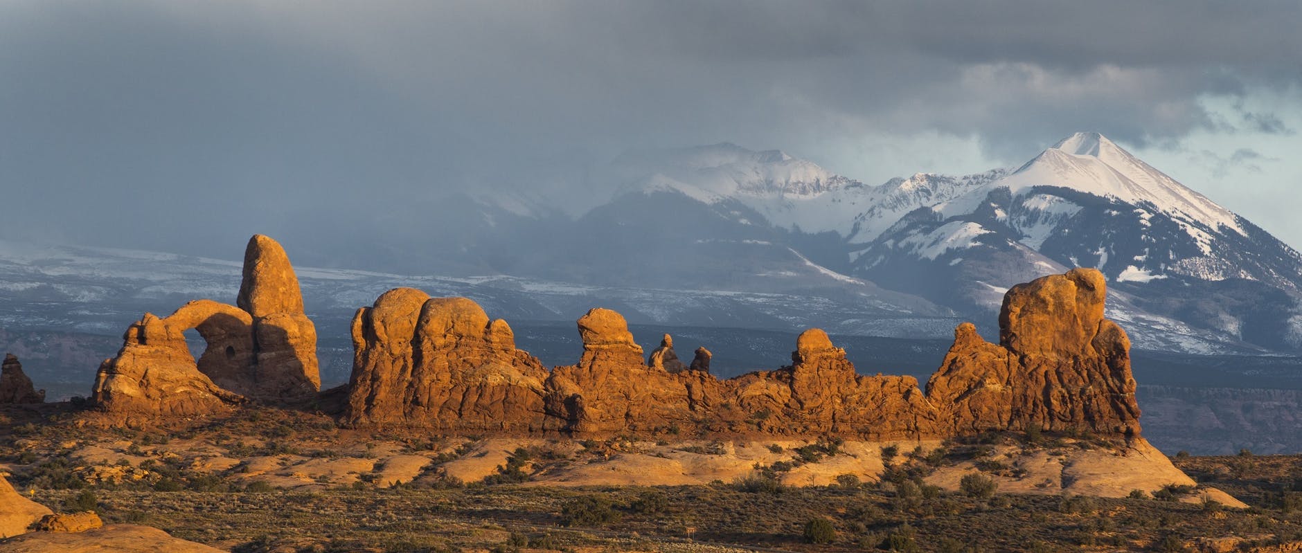 valley near snowy mountain during daytime