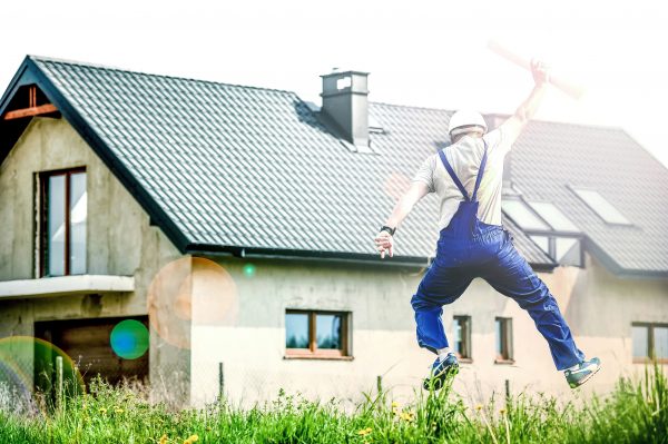 A builder architect jumping for success