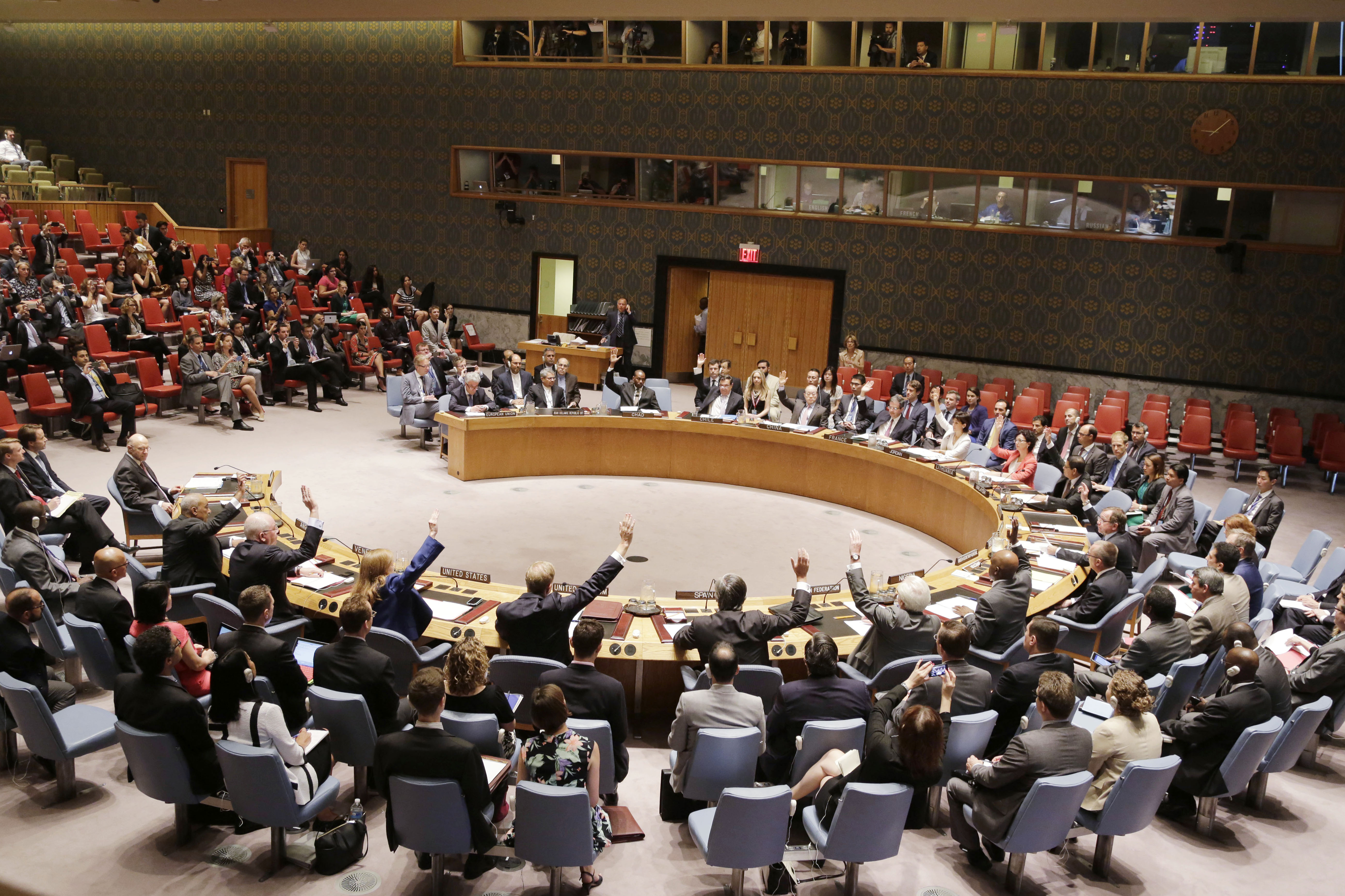 The UN Security Council takes a vote. Many representatives raise their hands.