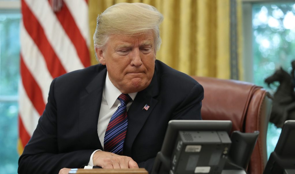 Trump speaks on the telephone via speakerphone with Mexican President Enrique Pena Nieto in the Oval Office of the White House on August 27, 2018 in Washington, DC.