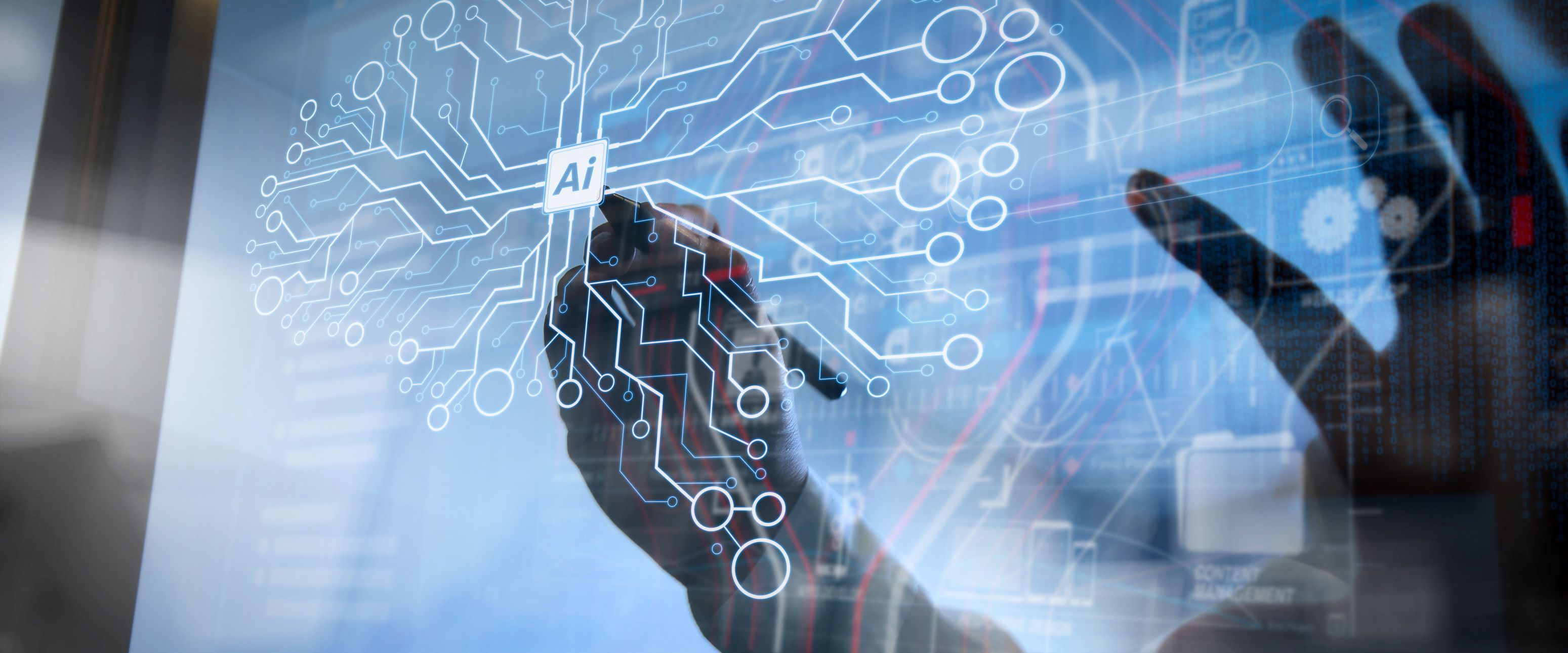 A hand draws on an electronic touch board the letters “AI” with lines and circles radiating outward.
