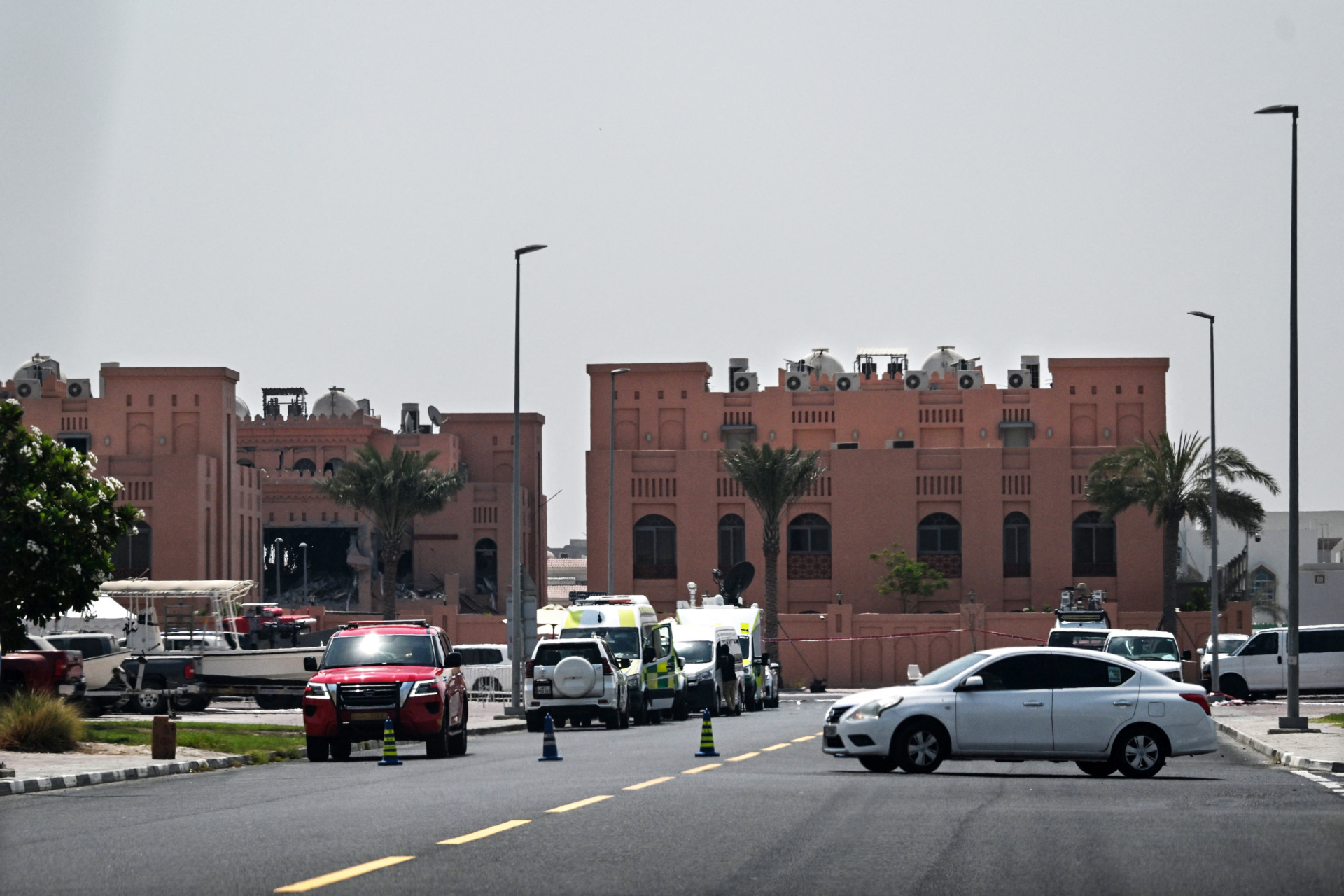 A picture taken from a distance shows the damaged building (L) in the compound housing members of Palestinian militant group Hamas's political bureau
