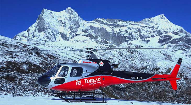 the heli is landed on the snow capped mountain in everest base camp