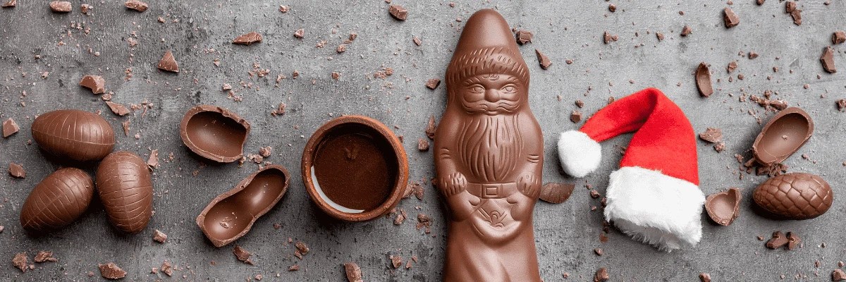 Christmas chocolates with a small santa hat on a slate table