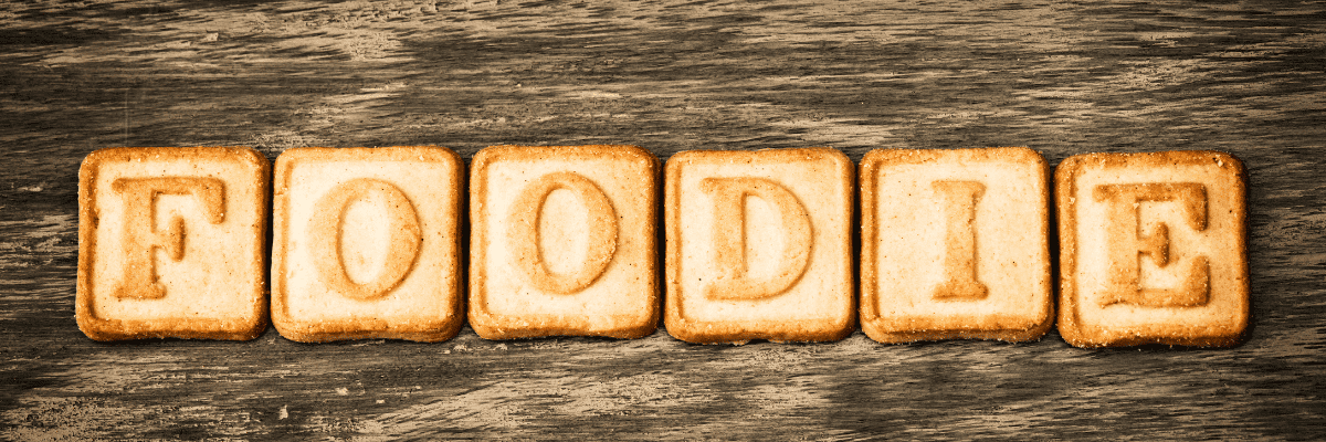 letter shortbread cookies spelling out Foodie on a wood table