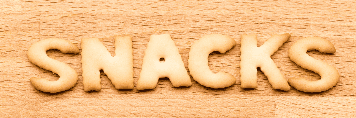 Photo of snack crackers spelling out snacks on a wood background