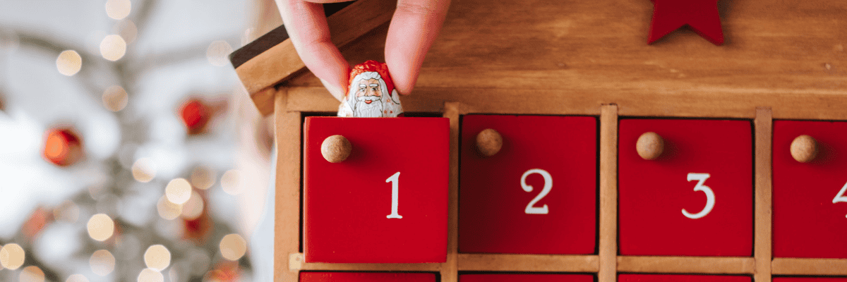 Picture of a person pulling a Santa Chocolate out of an advent calendar