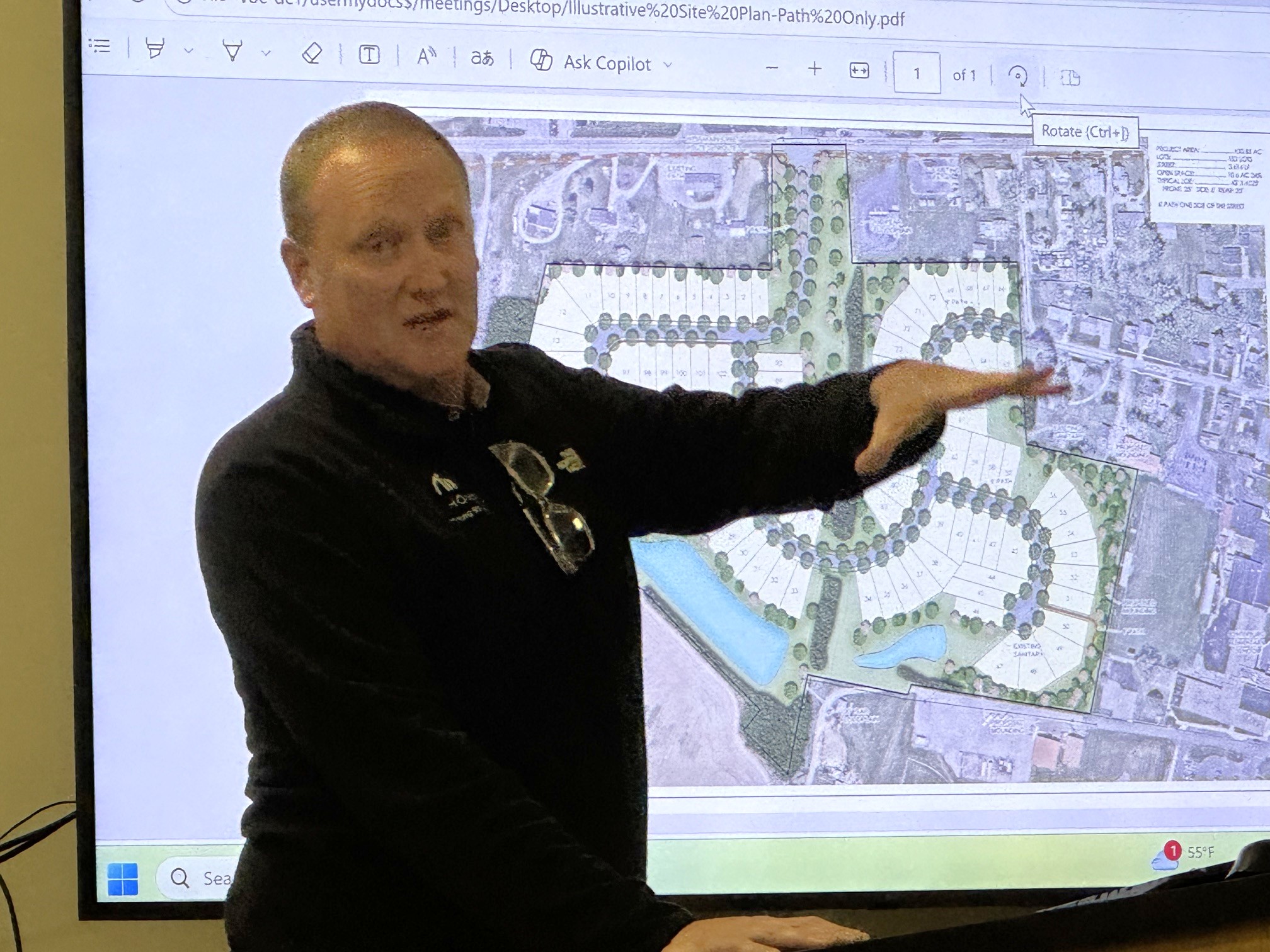 man in front of a projector screen