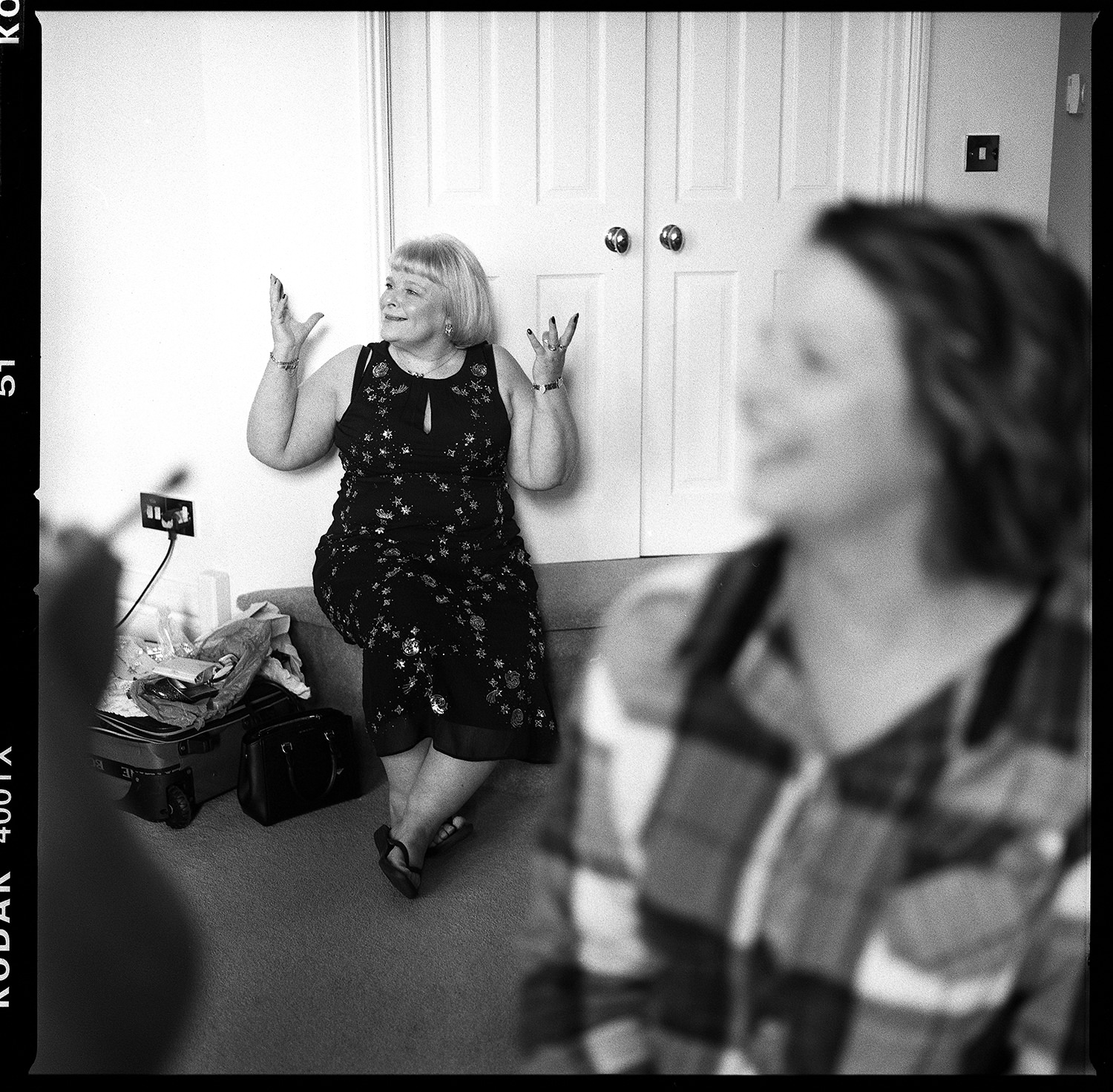 Chycara Wedding Hannah and Dan I photographed Hannah and Dan's wedding at Chycara tucked away in rural Cornwall. Chycara is a charming and discreet venue nestling deep in the Cornish countryside. The first time I visited to capture images, I was amazed at the tranquil green surroundings. Even the birds chirp quietly! Furthermore, Chycara's homely feel never fails to relax all that come here. Indeed, the bespoke alpine style lodges provide all that guests require. Across Cornwall Hannah and Dan's wedding service took place at Mawnan Smith Church on Cornwall's Helford River. The ancient little church is steeped in history. Unfortunately, it's interior is not steeped in natural light. In fact, it's quite dark in there! In this case, I would normally use flash photography to ensure well illuminated images. Unless of course the vicar decides to forbid flash*. And not allow me to move. Therefore, it's lucky that I use a second shooter at the other side of the church. Furthermore, my discreet silent shutter cameras with amazing light sensitivity can cope with such imposed conditions! Finally, once the service was over, the happy couple burst blinking into the beautiful natural light. Hurrah! After a frenzied confetti extravaganza and multiple group shots, we headed down the coast to Maenporth beach. Luckily for us, Hannah and Dan's limo driver was a speed demon. Consequently, we arrived at the beach before the ominous clouds decided to empty their cargo. That is to say, I spent the next 10 minutes feverishly shooting portraits before it pissed it down! Safely warm and dry in their limo, Hannah and Dan roared off across Cornwall to the reception at Chycara. Likewise, my second shooter and I gave chase, determined to be on hand to document the happy couple's grand entry. We needn't have worried though. We were almost the first people to arrive! Van life During the Chycara wedding reception and breakfast, the storm intensified. So it became clear that my hopes of further photography in Chycara's stunning surrounds may be dashed! Therefore, I began to hatch a plan. Most importantly, Hannah had expressed her wish to be photographed with her new husband at Chycara's wedding pagoda. In addition, she had requested the use of pink umbrellas in these images. Unfortunately, the pagoda was almost at the other end of the 16 acre site! Maybe there was something I could do to remedy the situation? Consequently, I pulled my trusty VW Transporter up to the venue doors. Hannah and Dan clambered into the back seat via the sliding door. After that, a 2 minute journey saw us draw up at the pagoda and deposit a bone dry couple safely under the roof ready for portraits! Apologies have to go out to the father of the bride. Maybe he had been purposely left out of the bridal prep dressing gown fitting? Either way, the flower girls fashioned a sign for him. Whether he was aware of the application of said sign to the rear of his gown, I'm not sure. In case you're wondering, photographic evidence exists further down the page. Thank you to Hannah and Dan for all the laughs, to Rob and the team at Chycara and to the extended families for the energetic dancing! *I'm pretty sure she said 'No flash' and not 'No flashing'.