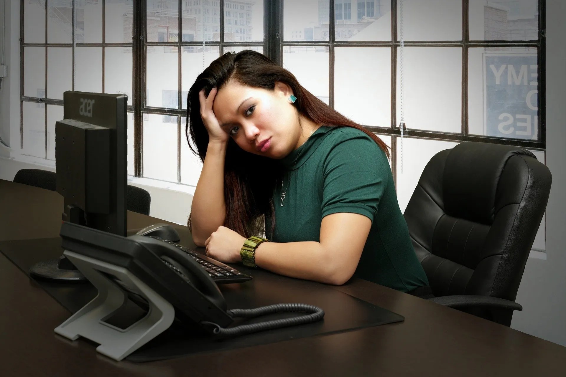 A woman feeling isolated and down | Dealing with Social Isolation at Work