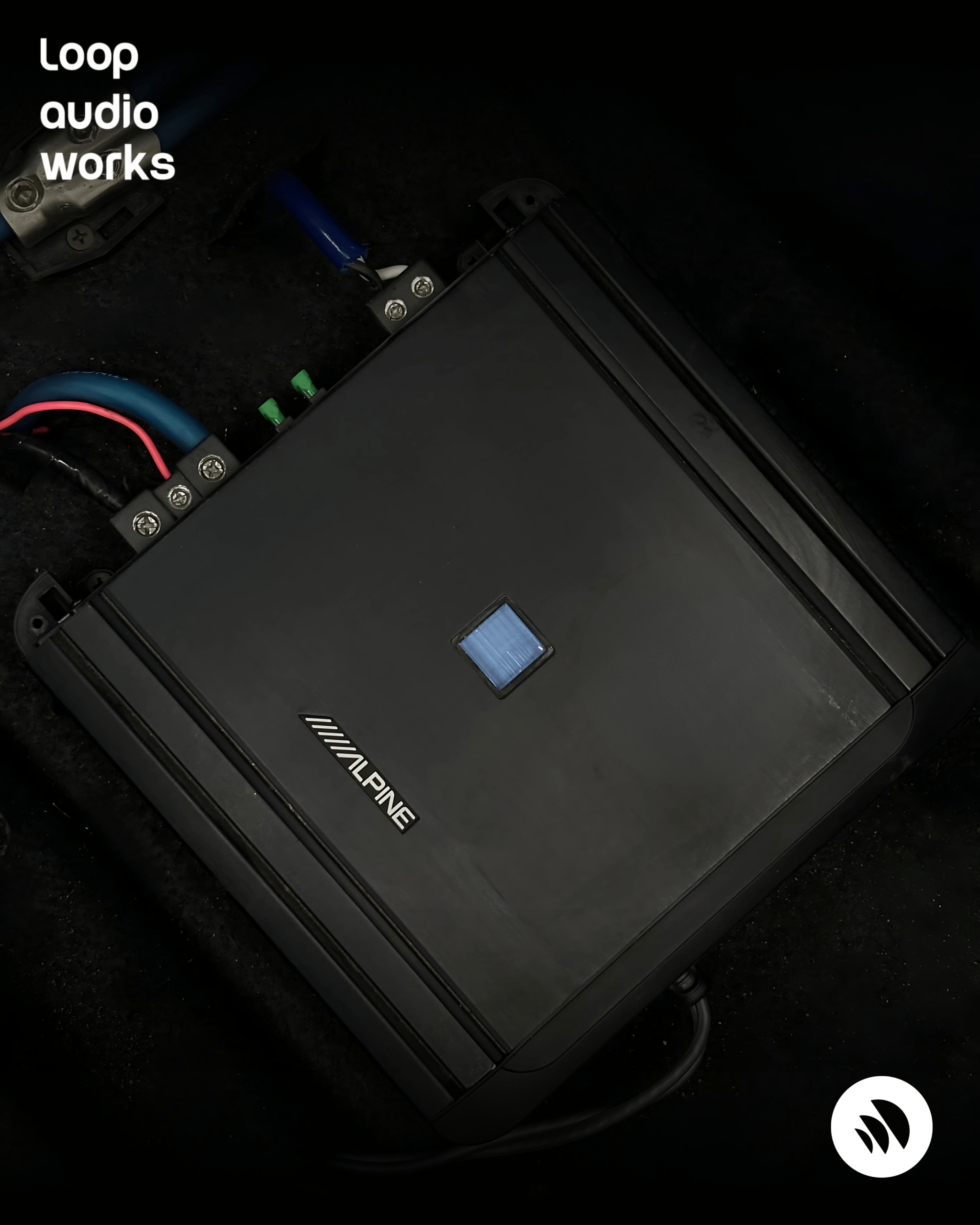 Alpine monoblock amplifier installed in a custom car audio setup with clean power wiring and fuse protection by Loop Audio Works