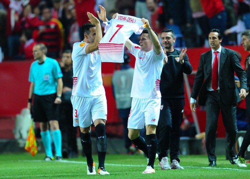 Sevilla's star striker Kevin Gamero celebrates his second goal by holding up the jersey of injured teammate Krohn Dehli. 