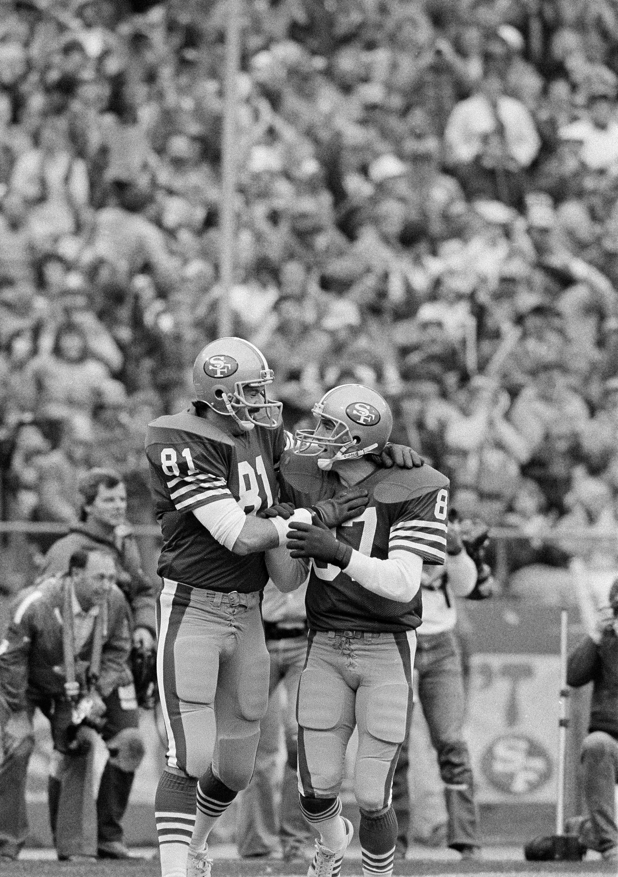 San Francisco 49ers wide receiver Dwight Clark, right, congratulates teammate tight end Russ Francis after Francis scored on a pass from quarterback Joe Montana in the first quarter of the 49ers 21-10 win over the New York Giants during first round NFC playoffs at Candlestick Park, Dec. 31, 1984. The 49ers will play the Chicago Bears for the NFC Championship at Candlestick Park next Sunday. (AP Photo)