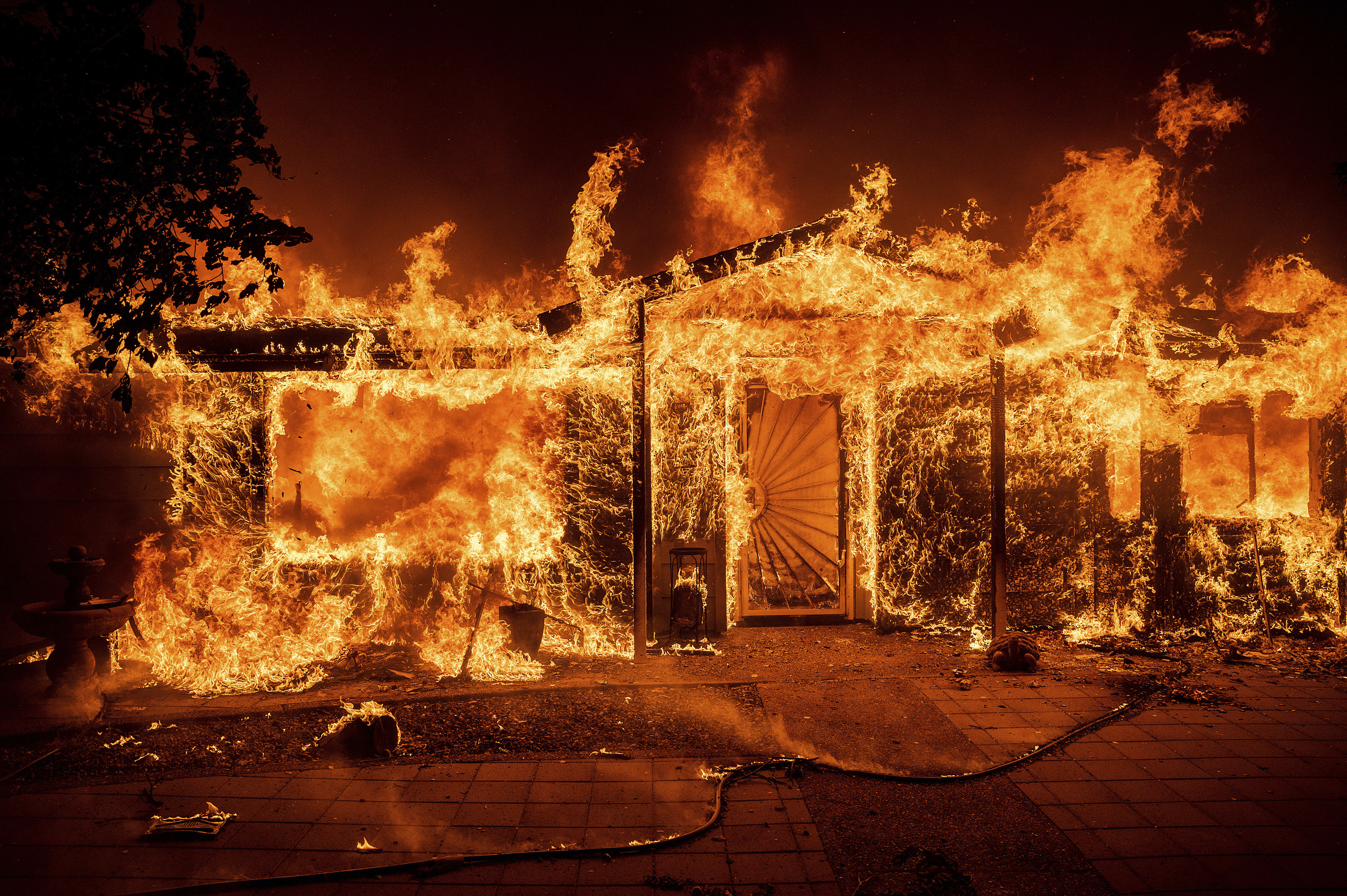 Flames consume a home on Triangle Road as the Oak Fire burns in Mariposa County, Calif., on Saturday, July 23, 2022. (AP Photo/Noah Berger)