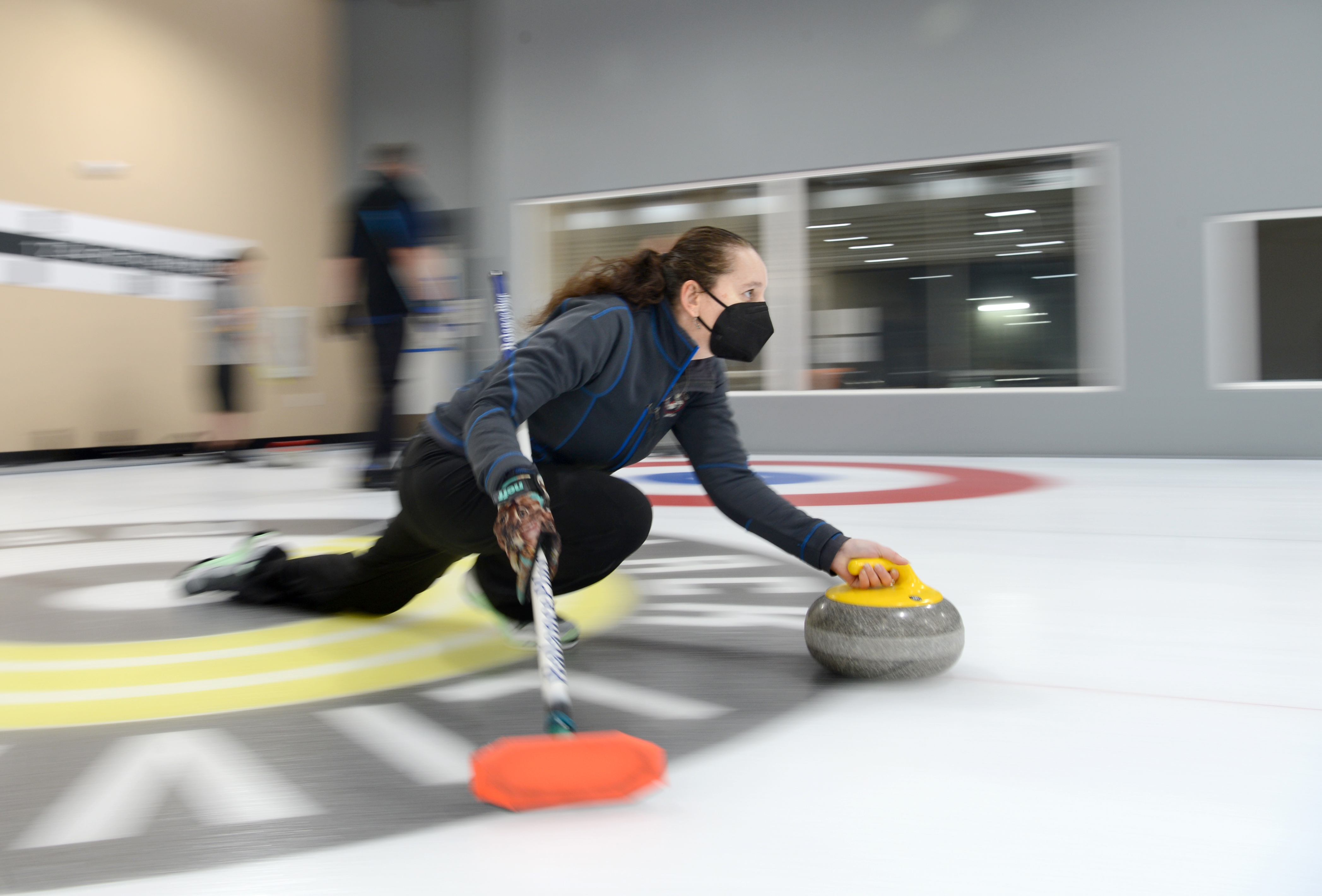 OAKLAND, CA - MARCH 31: Sarah Walsh of Oakland, slides a stone down the ice during a club league night at the San Francisco Bay Area Curling Club's new curling facility in Oakland, Calif., on Thursday, March 31, 2022. (Doug Duran/Bay Area News Group)