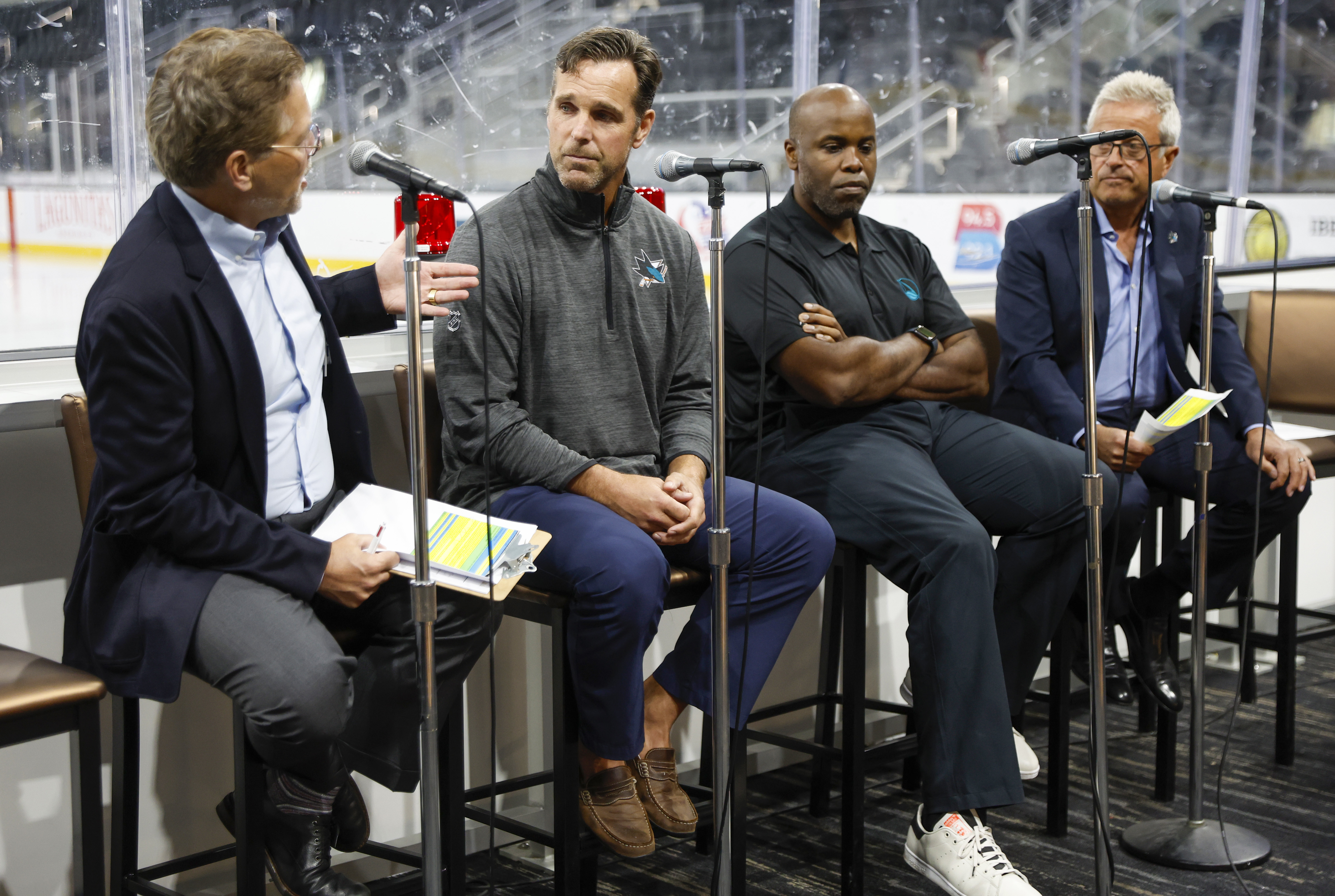 SAN JOSE, CALIFORNIA - SEPTEMBER 14: From left to right, San Jose Sharks play-by-play commentator Dan Rusanowsky, San Jose Sharks head coach David Quinn, San Jose Sharks general manager Mike Grier and San Jose Sharks play-by-play commentator Randy Hahn talk about the upcoming season during an event for San Jose Sharks' season ticket holders at the Tech CU Arena in San Jose, Calif., on Wednesday, Sept. 14, 2022. (Nhat V. Meyer/Bay Area News Group)