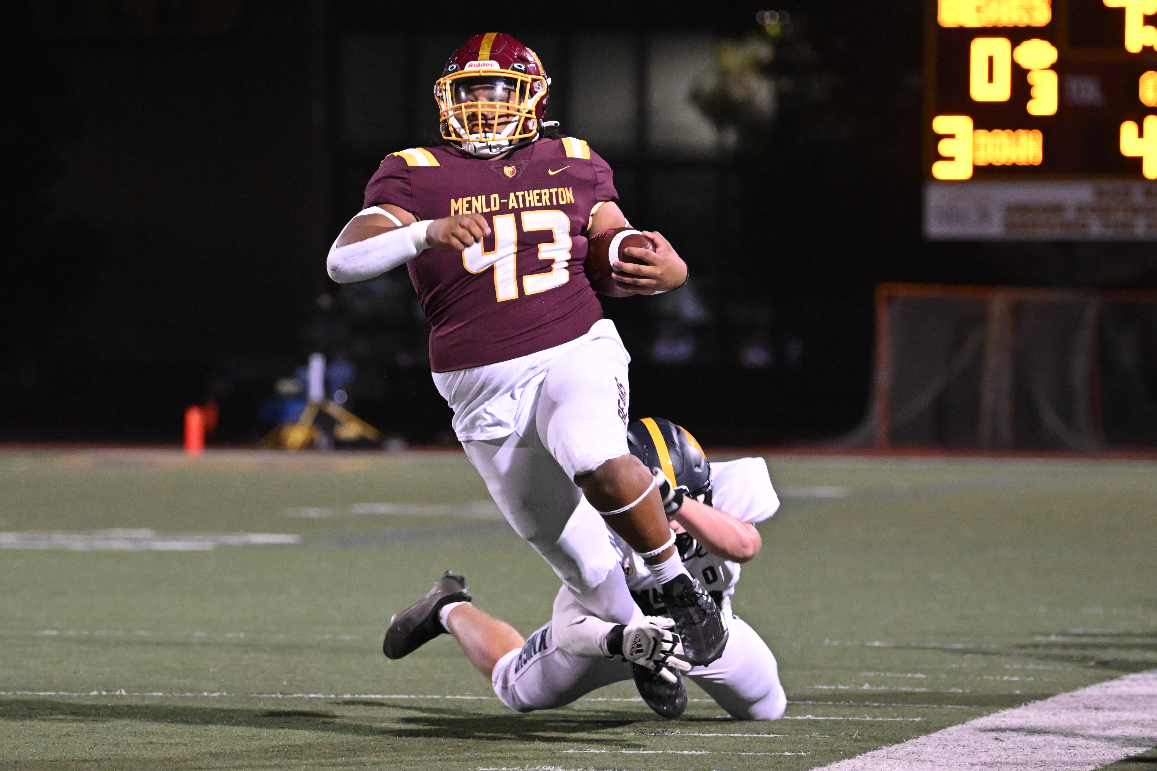 Menlo Atherton's Jordan Masuisui (43) runs with the ball while playing Menlo during their game on Oct. 21, 2022, in Atherton, Calif. (Thien-An Truong for Bay Area News Group)