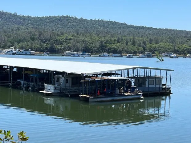 Boats are parked at the end of Bidwell Canyon Marina and, in the distance on the water of Lake Oroville on Monday, May 15, 2023 in Oroville, California. (Jennie Blevins/Mercury-Register)