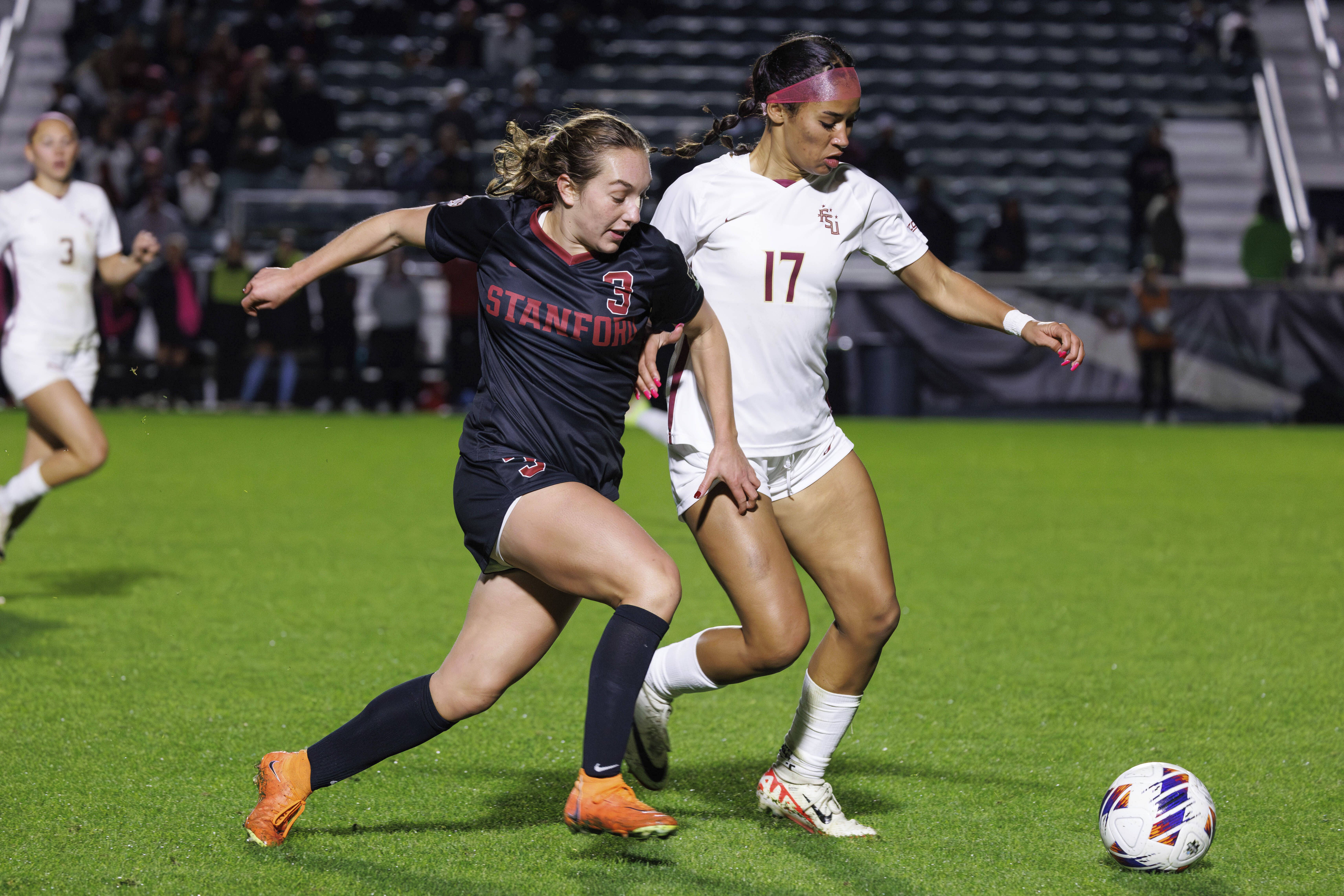 Stanford's Allie Montoya (3) and Florida State's Mimi Van Zanten (17) battle for a ball during the second half of the NCAA college women's soccer tournament final in Cary, N.C., Monday, Dec. 4, 2023. (AP Photo/Ben McKeown)