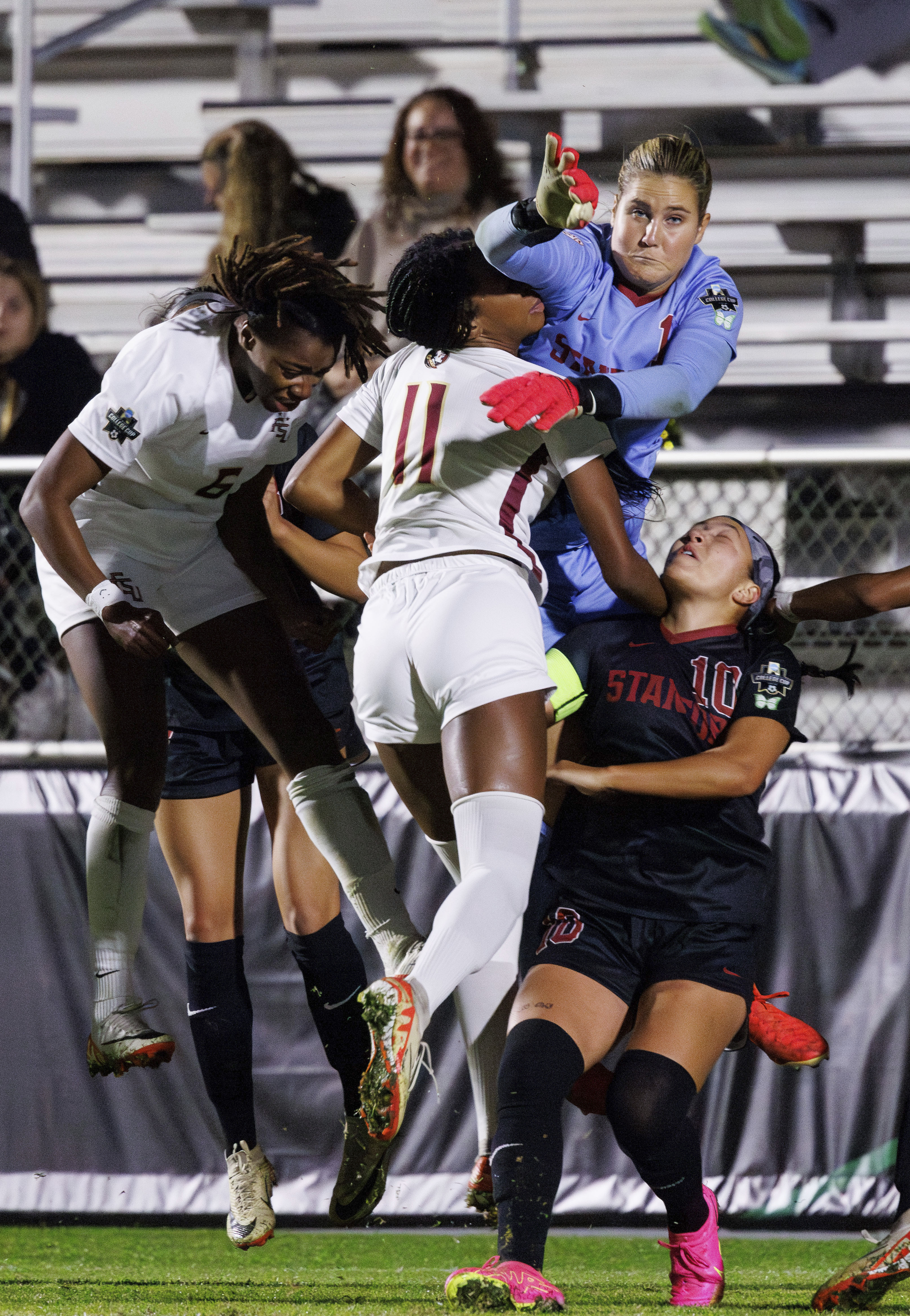 Stanford's Ryan Campbell (1) and Maya Doms (10) collide with Florida State's Jordynn Dudley (11) and Onyi Echegini (6) in front of the goal during the first half of the NCAA college women's soccer tournament final in Cary, N.C., Monday, Dec. 4, 2023. (AP Photo/Ben McKeown)