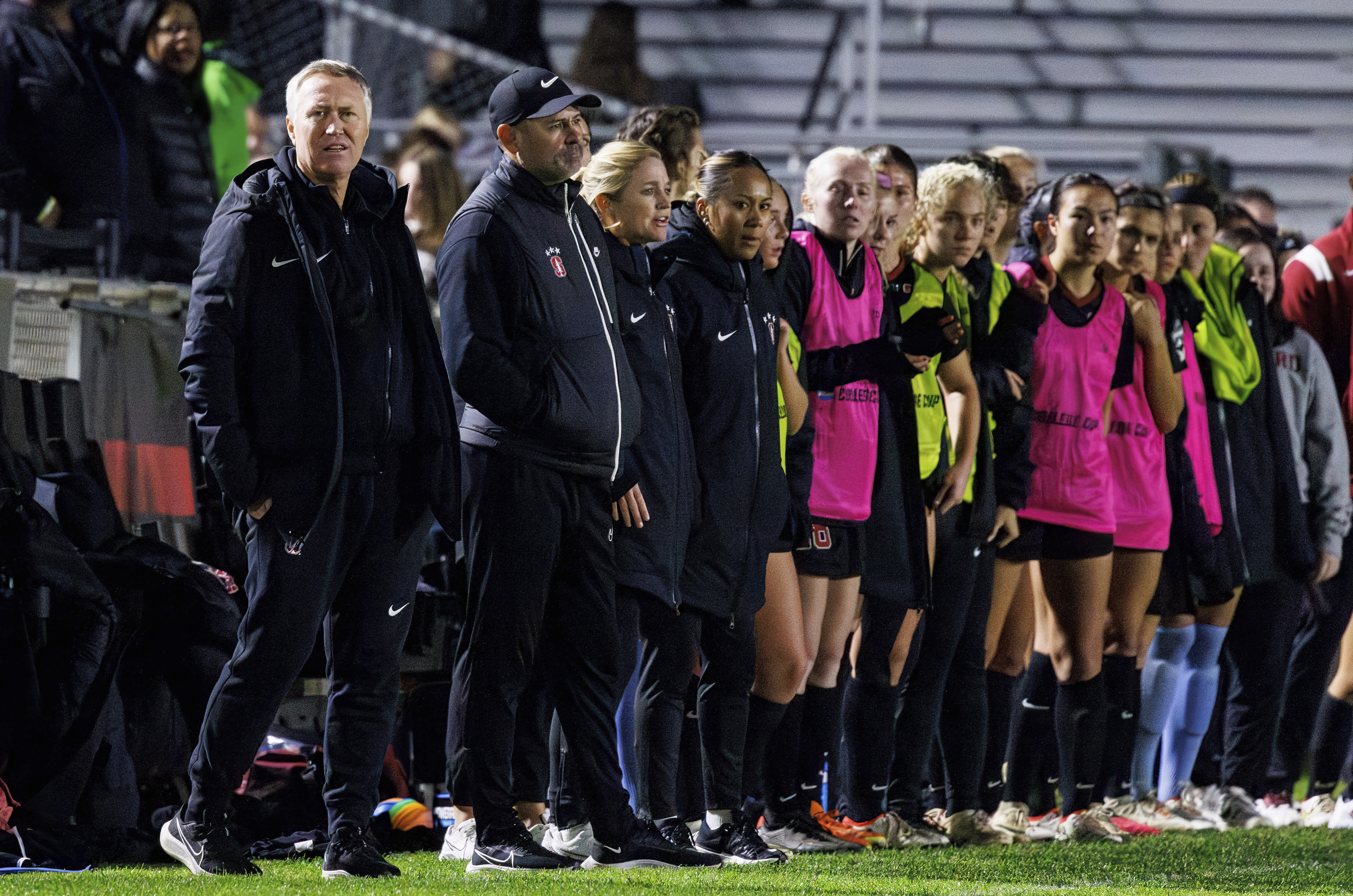 Stanford head coach Paul Ratcliffe, left, looks onto the field in the final minutes of the NCAA college women's soccer tournament final against Florida State in Cary, N.C., Monday, Dec. 4, 2023. (AP Photo/Ben McKeown)