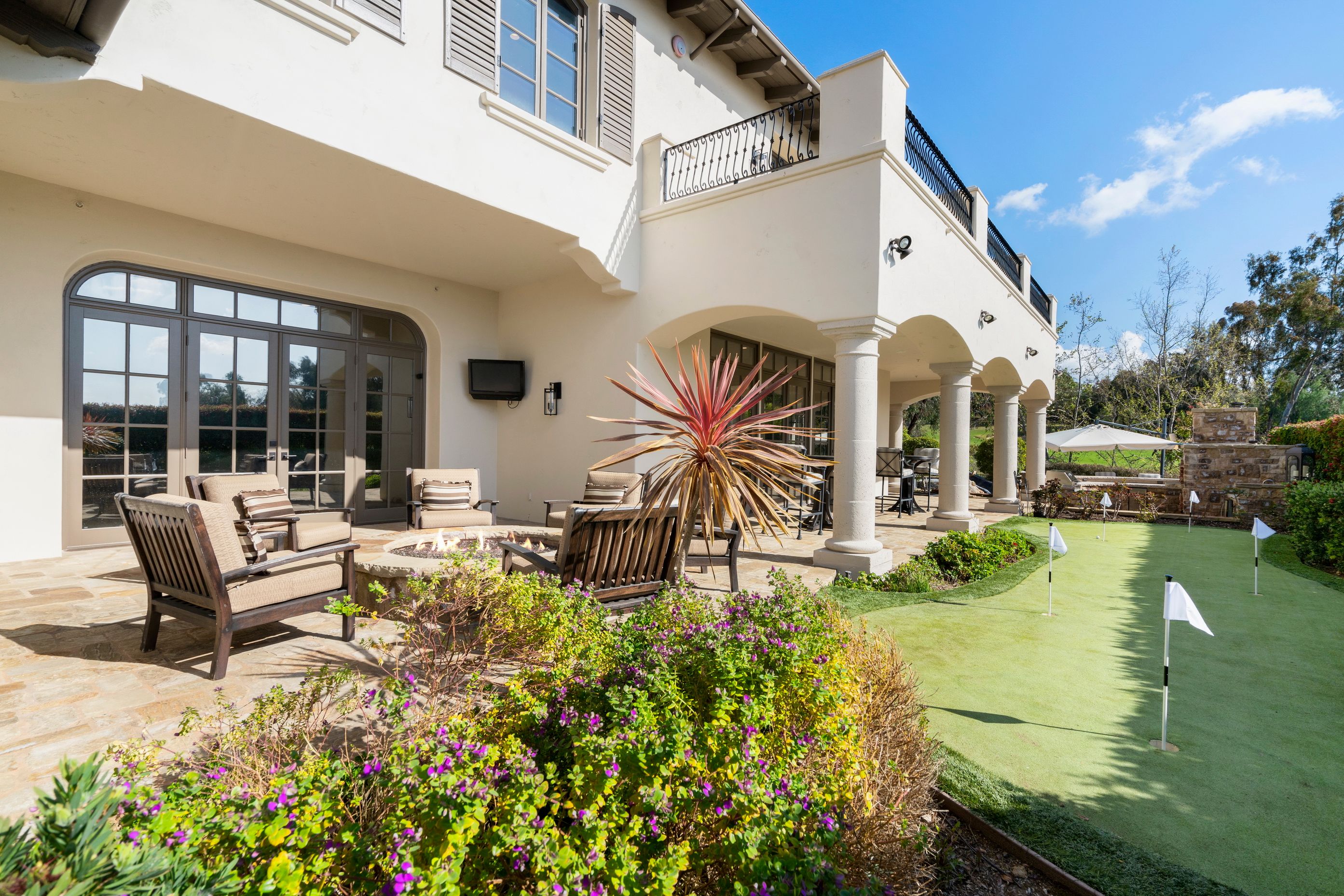 Backyard tables overlooking mini-golf green.