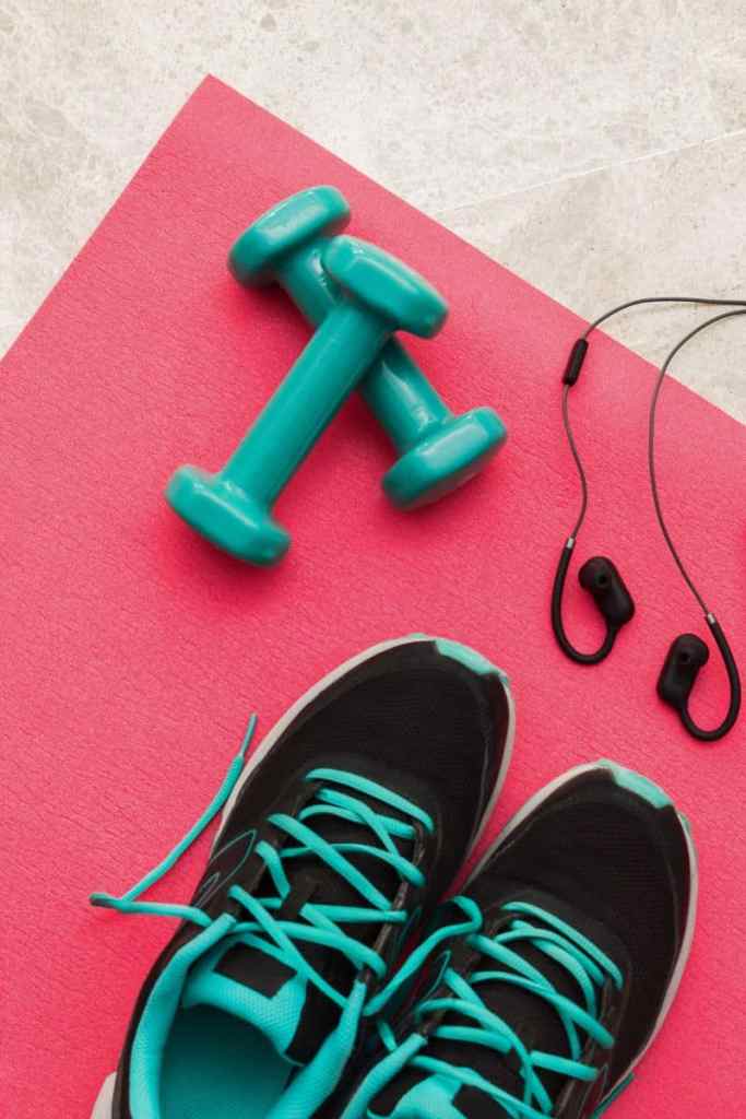 Migraines and exercise tips with tennis shoes, weights, and yoga mat