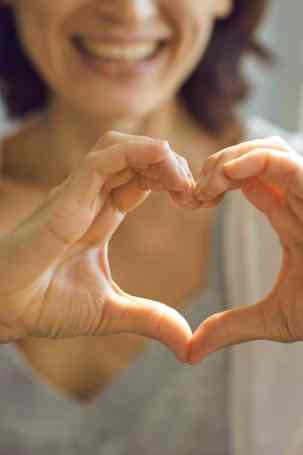 Migraine Journey: Woman making heart with hands