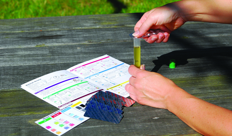 Person at table using Mosser Lee Soil Master Soil Test Kit