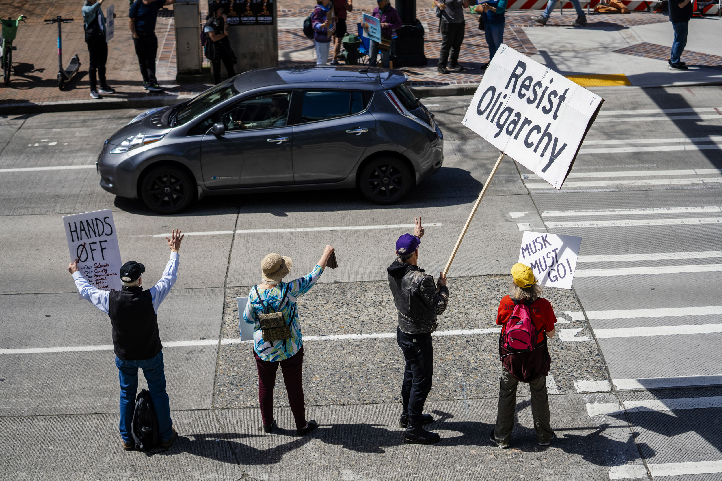 People rally in support of federal workers outside the Henry M. Jackson Federal Building in Seattle, Washington, USA, on Fri., April 25, 2025. Since the inauguration of President Donald Trump and his appointment of Elon Musk to the Department of Government Efficiency (DOGE) federal workers have faced uncertainty and layoffs around the country.