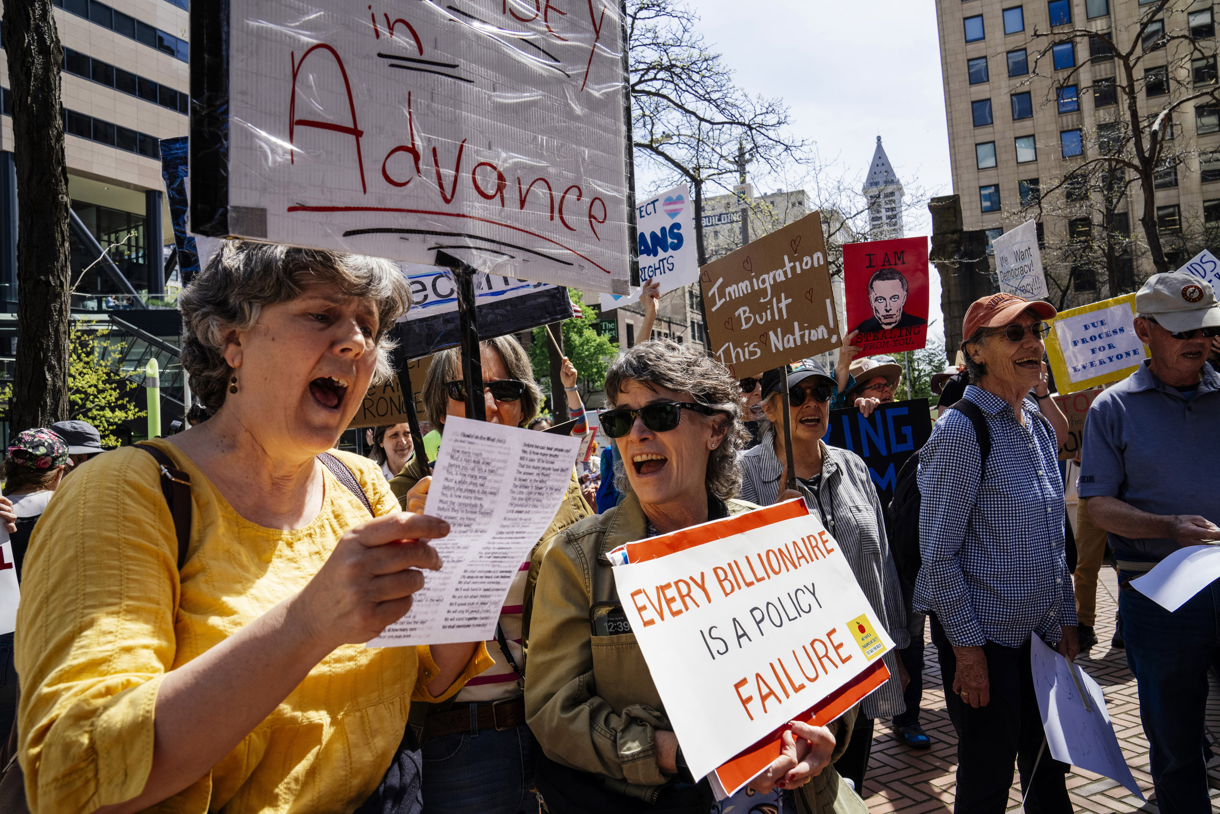 People rally in support of federal workers outside the Henry M. Jackson Federal Building in Seattle, Washington, USA, on Fri., April 25, 2025. Since the inauguration of President Donald Trump and his appointment of Elon Musk to the Department of Government Efficiency (DOGE) federal workers have faced uncertainty and layoffs around the country.