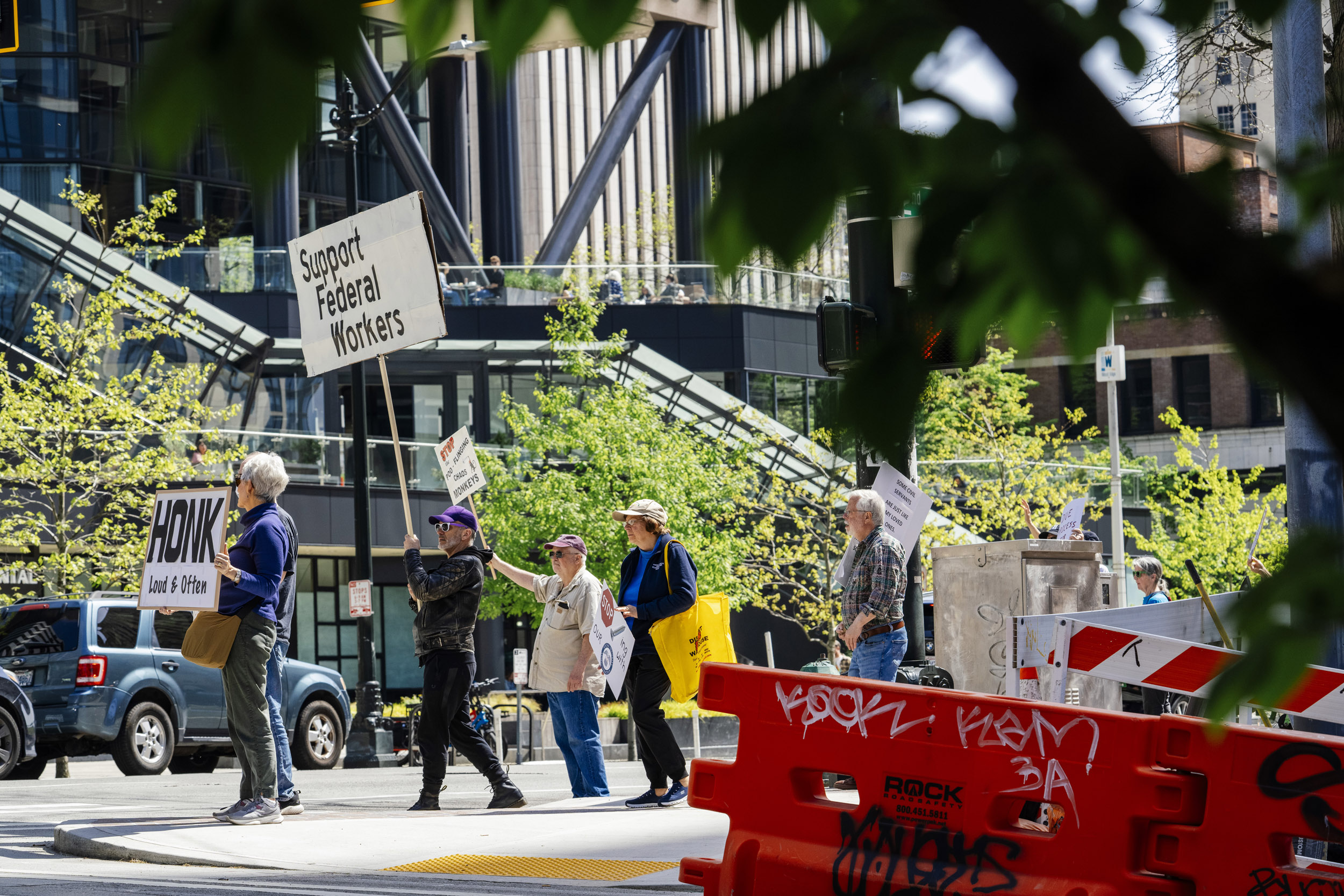 People rally in support of federal workers outside the Henry M. Jackson Federal Building in Seattle, Washington, USA, on Fri., April 25, 2025. Since the inauguration of President Donald Trump and his appointment of Elon Musk to the Department of Government Efficiency (DOGE) federal workers have faced uncertainty and layoffs around the country.