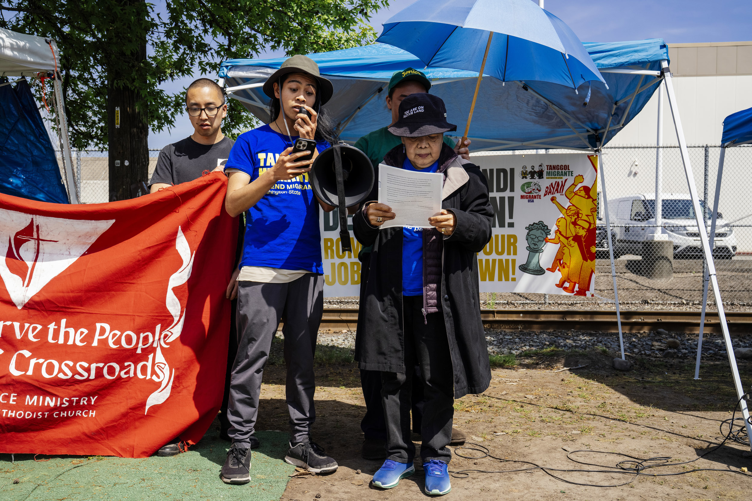 Activists read a letter from detained green card-holder Ate Michelle as Tanggol Migrante activists and supporters gather outside the Northwest Detention Center to rally in support of detained Filipina immigrants Ate Michelle, Lewelyn Dixon, and other detainees in Tacoma, Washington, USA, on Wed., April 30, 2025. Ate Michelle is a green card holder and mother of three; Lewelyn Dixon has had her green card for more than 50 years. Both women are being held by Immigration and Customs Enforcement at the Tacoma facility. Tanggol Migrante is calling for their release and for the Filipino government to support citizens in detention.
