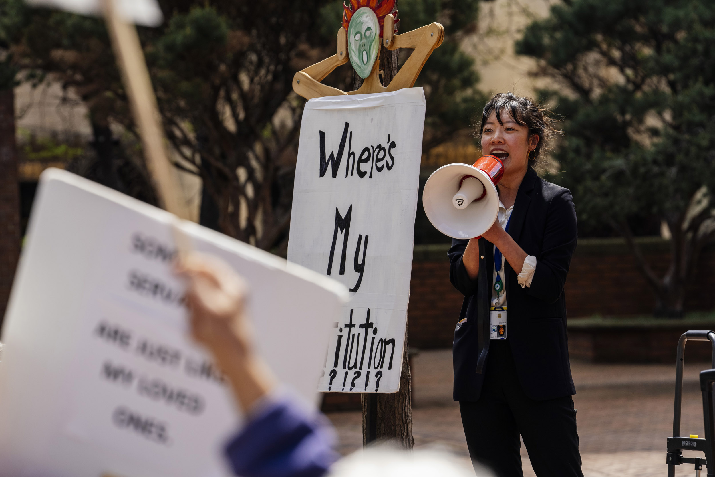 Stephanie (last name withheld), a federal worker and member of the American Federation of Government Employees (AFGE), speaks to the crowd as people rally in support of federal workers outside the Henry M. Jackson Federal Building in Seattle, Washington, USA, on Fri., May 2, 2025. Since the inauguration of President Donald Trump and his appointment of Elon Musk to the Department of Government Efficiency (DOGE) federal workers have faced uncertainty and layoffs around the country.