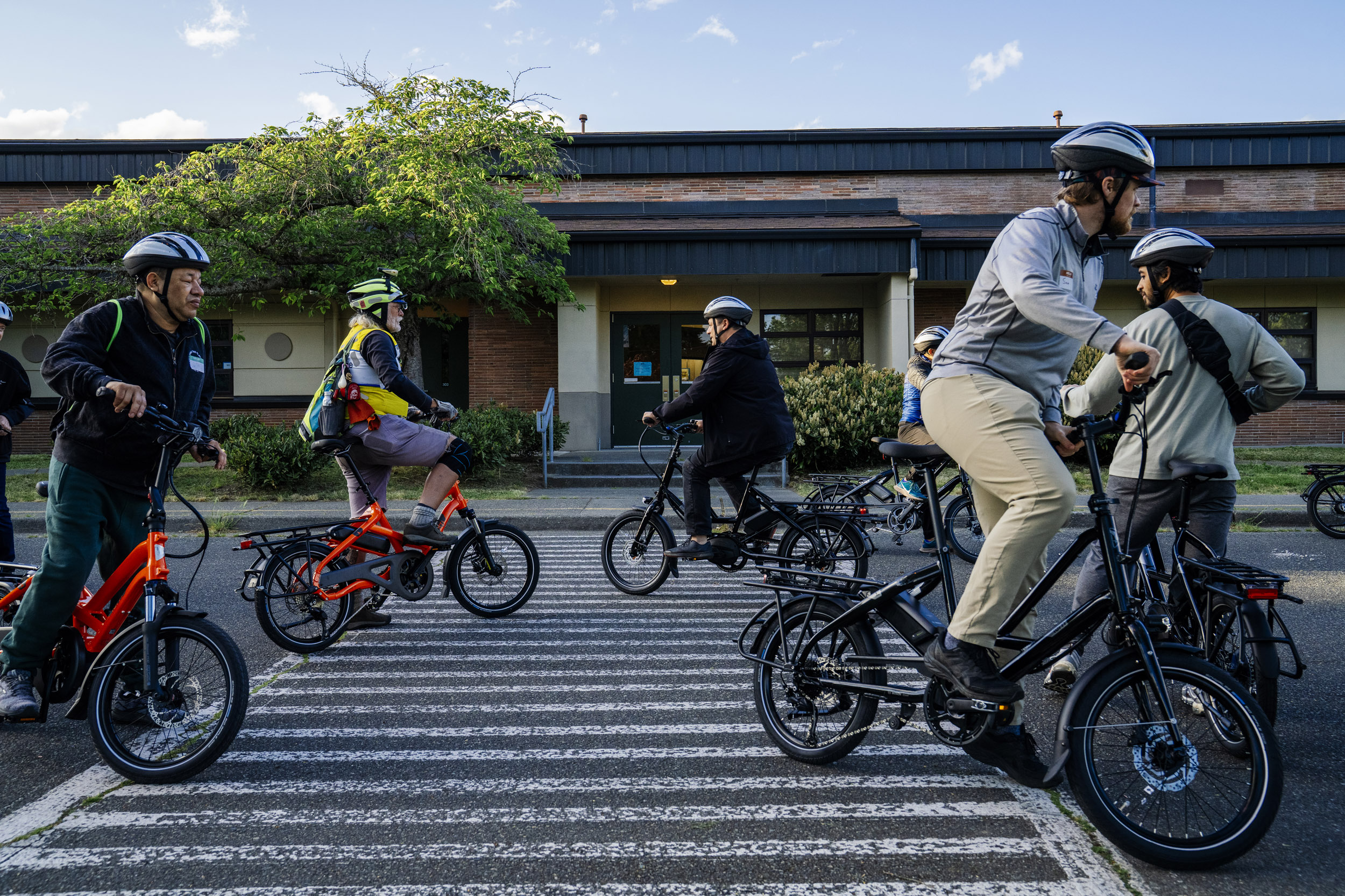 Pedal Forward Shoreline participants take part in an e-bike-focused urban cycling class put on by Cascade Bicycle Club at Ridgecrest Elementary School in Shoreline, Washington, USA, on Wed., May 7, 2025. Pedal Forward Shoreline is a program to give free e-bikes to residents in what has been deemed an “overburdened community” determined to have health, social, and environmental inequities at the south end of Shoreline east of I-5. As part of an effort to reduce driving in the city, the program will give out approximately 100 e-bikes to residents in the neighborhood, prioritizing households with incomes at or below 80% of the King County median income.   (M. Scott Brauer / Cascade PBS)