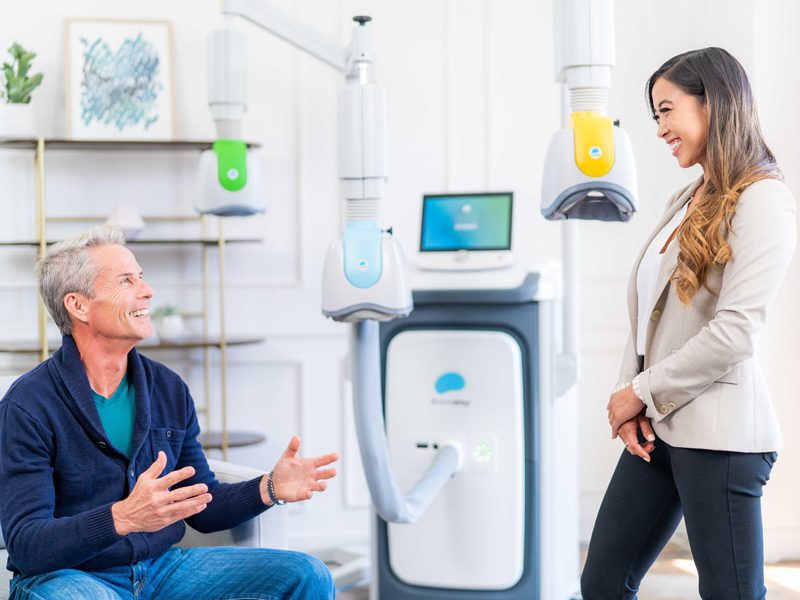 Photo of a patient and provider speaking in a TMS treatment room