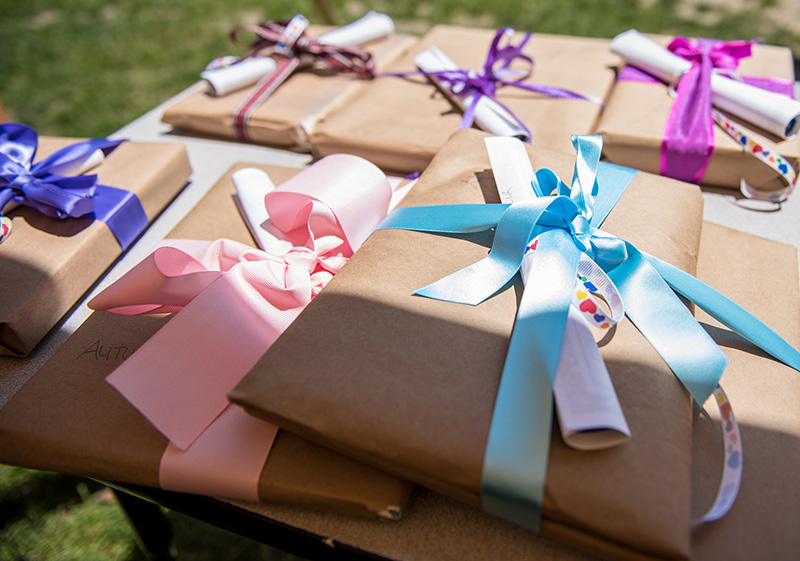Each of the 11 graduates received books and gifts with their student awards.