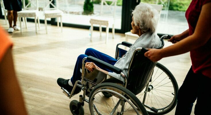 Senior sitting in a wheelchair in a nursing home