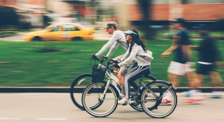 Woman and man riding on bike