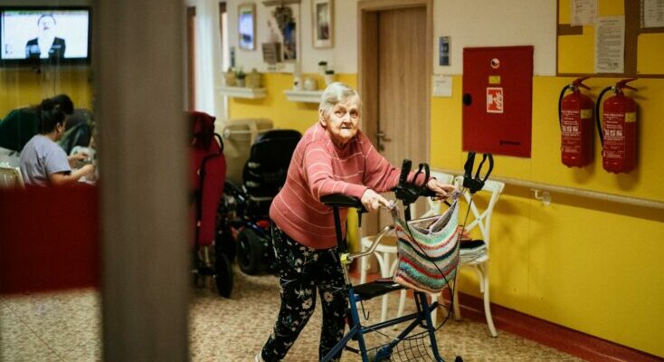 Woman with walking frame in nursing home