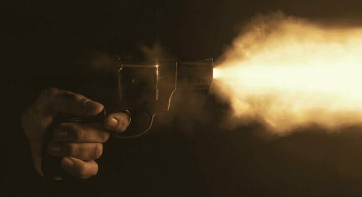 Man firing a gun