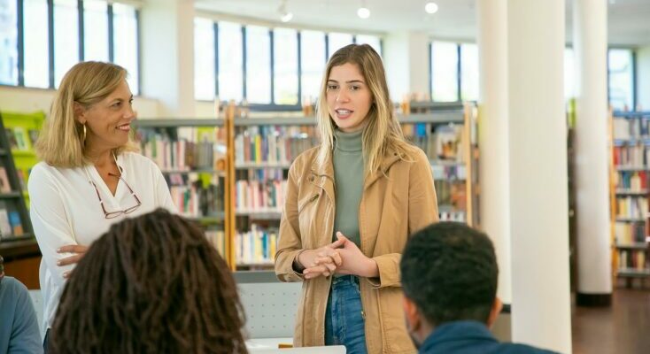 Young student making presentation to classmates and teacher