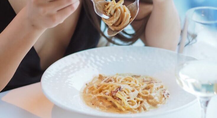 Woman eating spaghetti