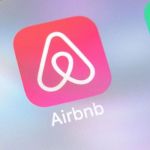 close-up of a smartphone screen displaying an icon for an Airbnb app. If you need pest control in your Airbnb, call now!