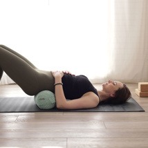 supported bridge with a yoga bolster