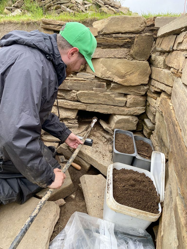 Ingenious! Liam excavating the Structure Twelve drain with some custom-made equipment. (📷 Jo Bourne)
