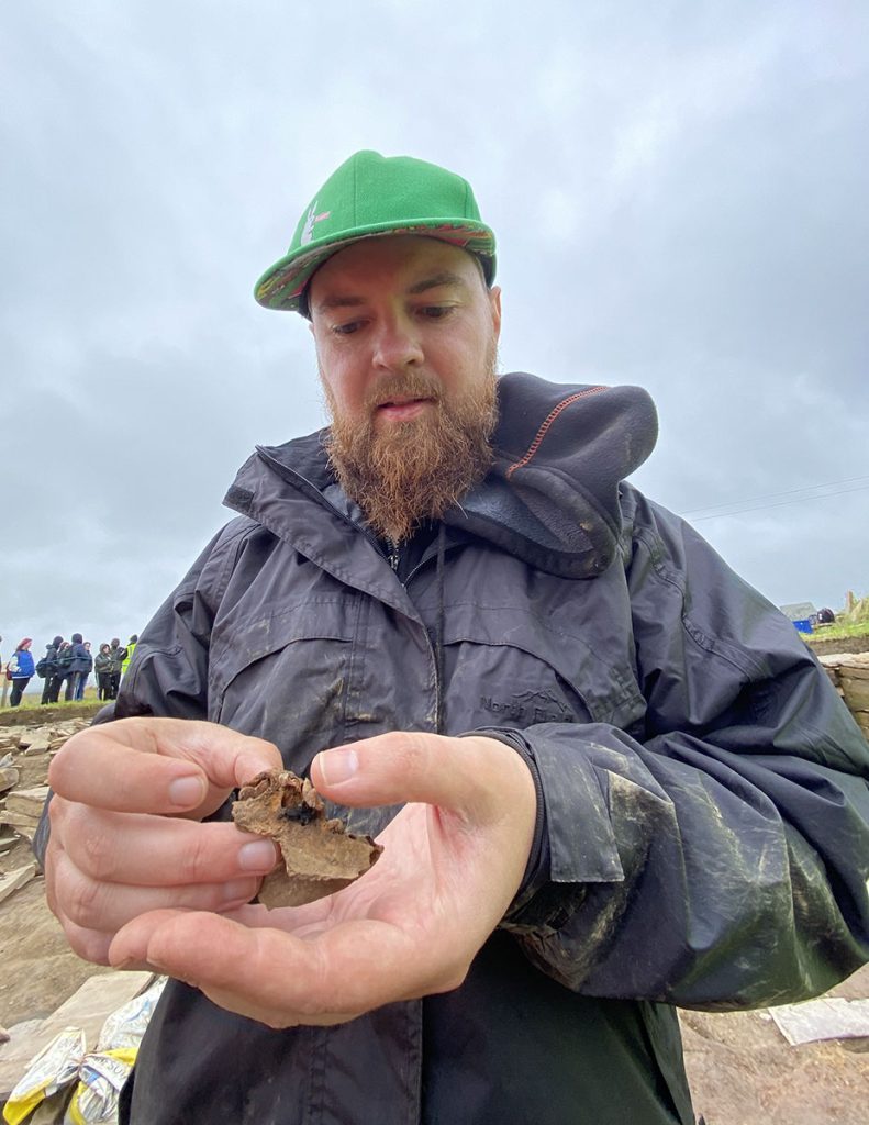 Liam with the fragment of canine mandible. (📷 Jo Bourne)