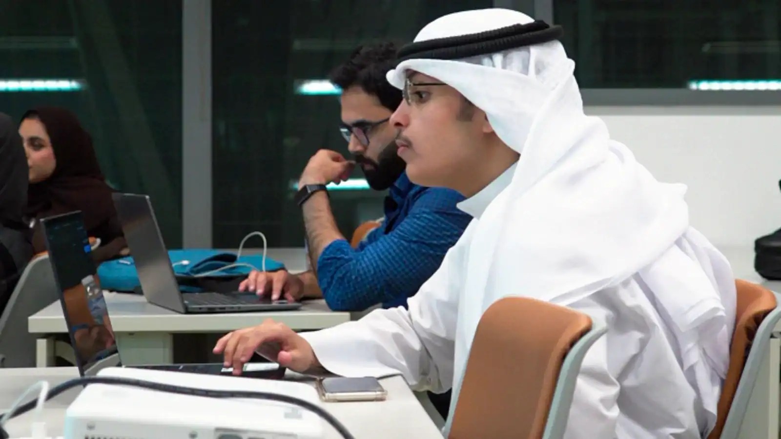 Participants working on laptops during a KFAS Future Educator workshop