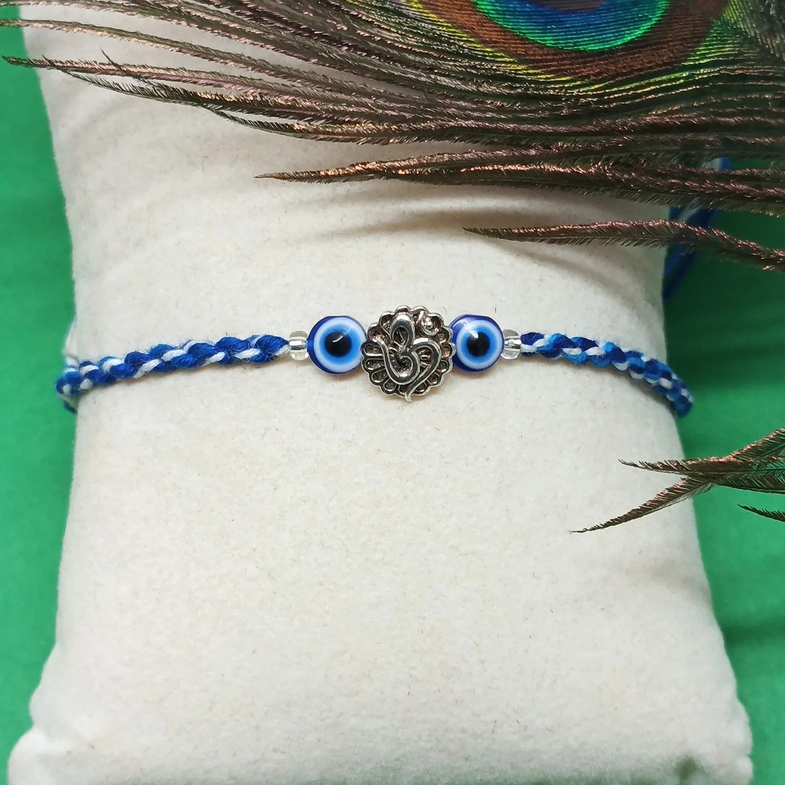 Evil Eye & Om Charm Rakhi with Roli and Chawal