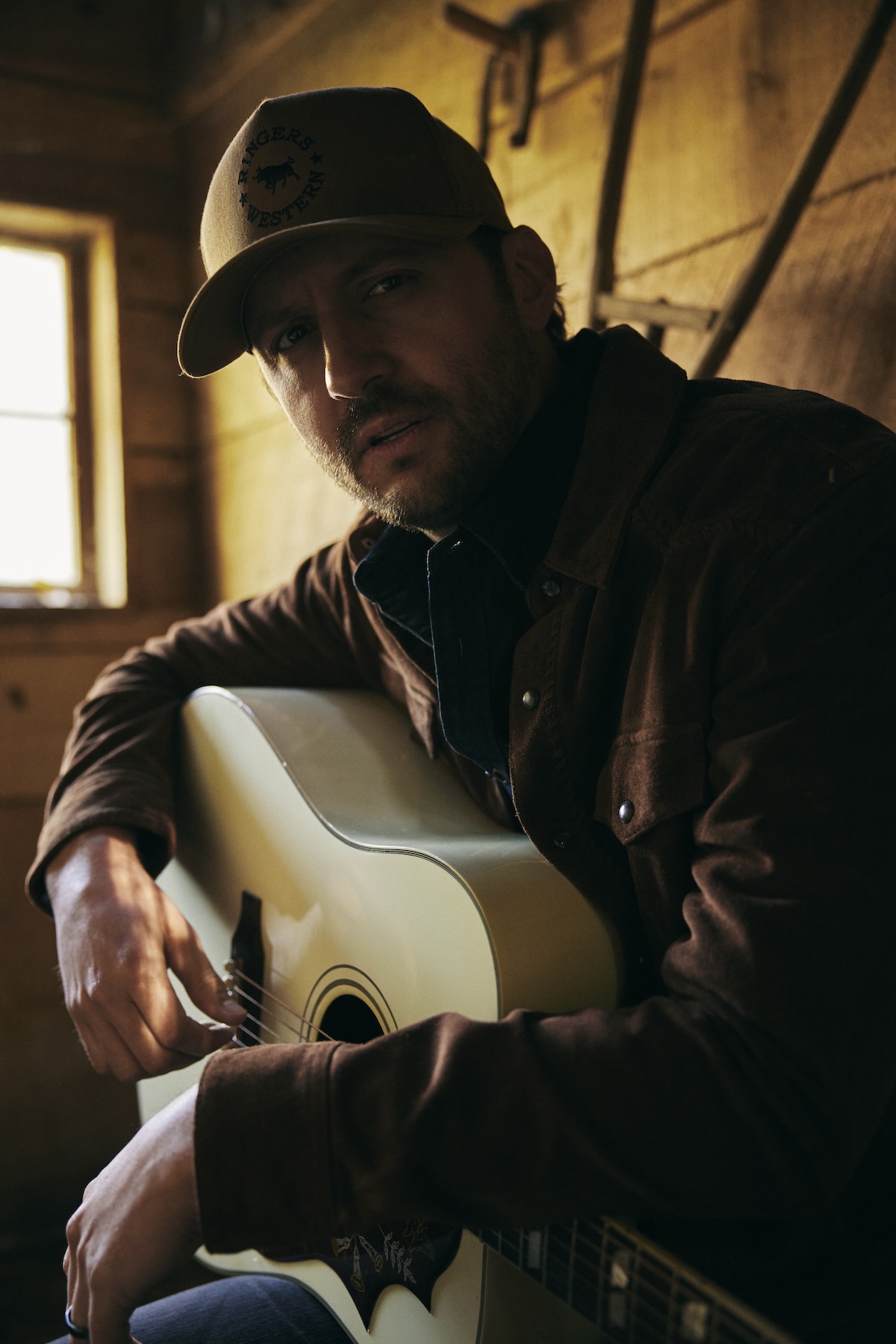 Drew Baldridge performing outdoors with guitar